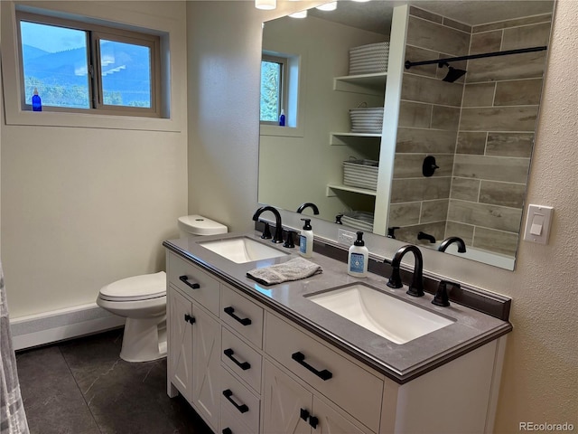 9081 Range Ln, Salida, CO 81201 - full bathroom with double vanity, a baseboard radiator, a tile shower, and tile patterned flooring