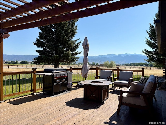 9081 Range Ln, Salida, CO 81201 - wooden terrace with an outdoor fire pit, a mountain view, a pergola, and grilling area