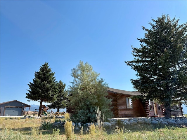 9081 Range Ln, Salida, CO 81201 - view of property exterior with log siding and a detached garage