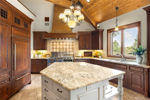 kitchen with light stone counters, a kitchen island, lofted ceiling with beams, decorative backsplash, and stainless steel stove