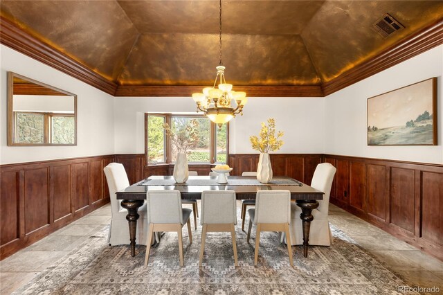 dining area with visible vents, wainscoting, a raised ceiling, and crown molding