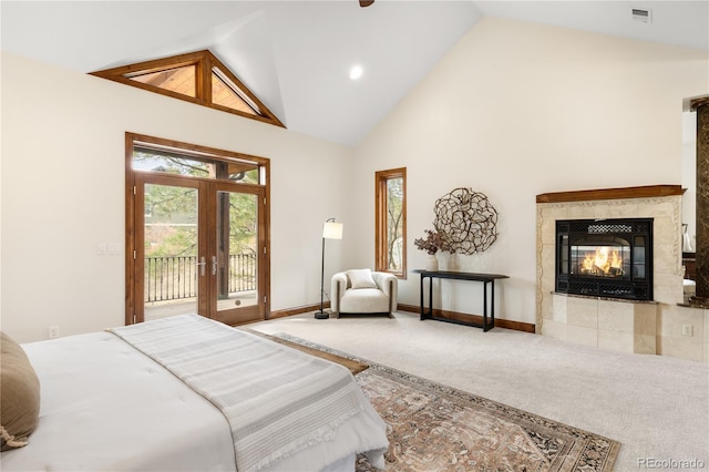 carpeted bedroom featuring access to exterior, visible vents, a fireplace, french doors, and high vaulted ceiling