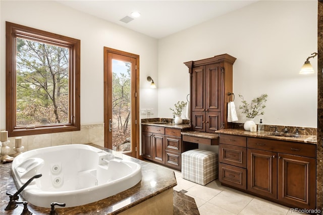 full bathroom featuring tile patterned flooring, visible vents, vanity, and a whirlpool tub