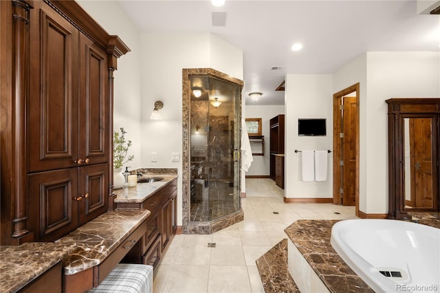 bathroom with visible vents, a sink, a shower stall, tile patterned flooring, and a bath