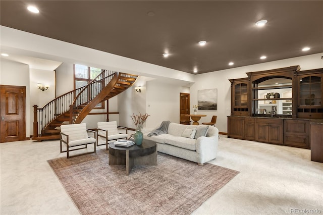 living room featuring stairway, recessed lighting, and light carpet