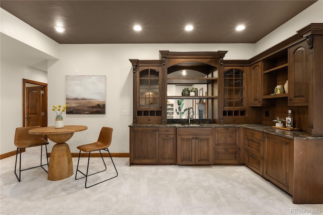 bar with recessed lighting, light colored carpet, baseboards, and a sink