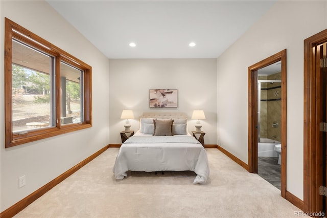 bedroom featuring connected bathroom, recessed lighting, baseboards, and light carpet