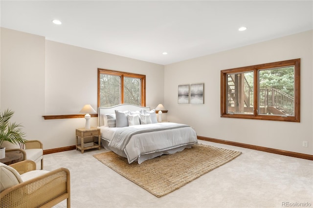 bedroom with recessed lighting, light colored carpet, and baseboards