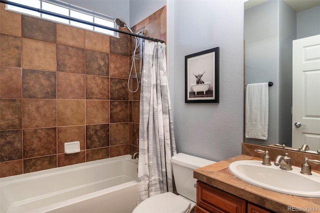 full bathroom with vanity, shower / tub combo, and toilet