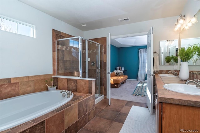 bathroom featuring vanity and independent shower and bath