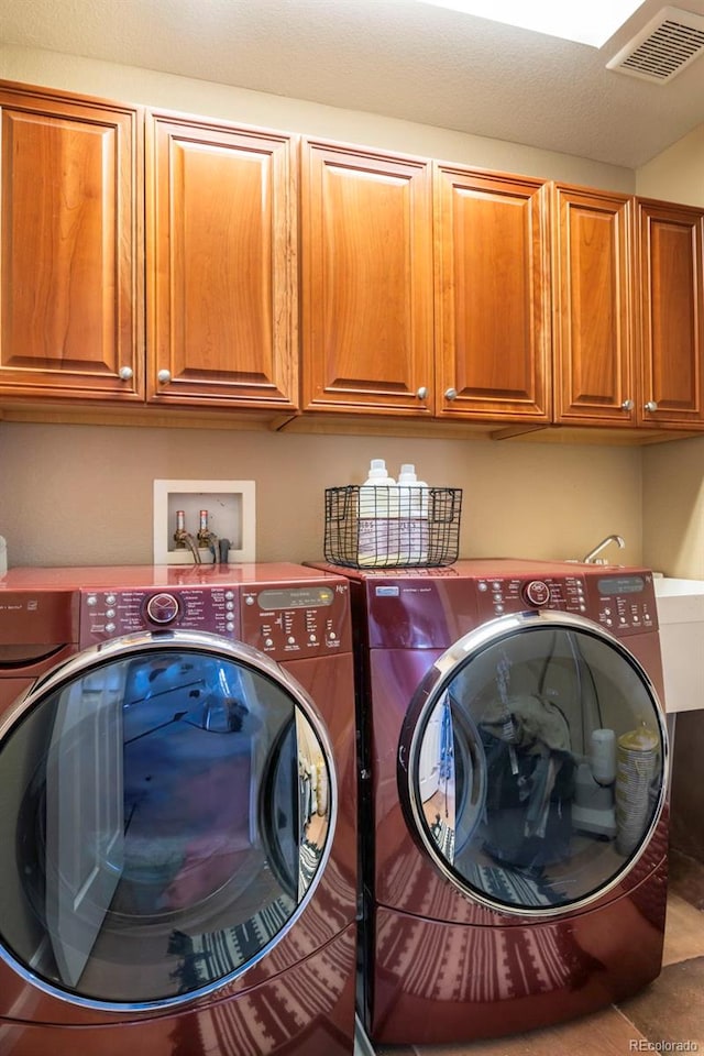 laundry room with cabinets and washing machine and clothes dryer