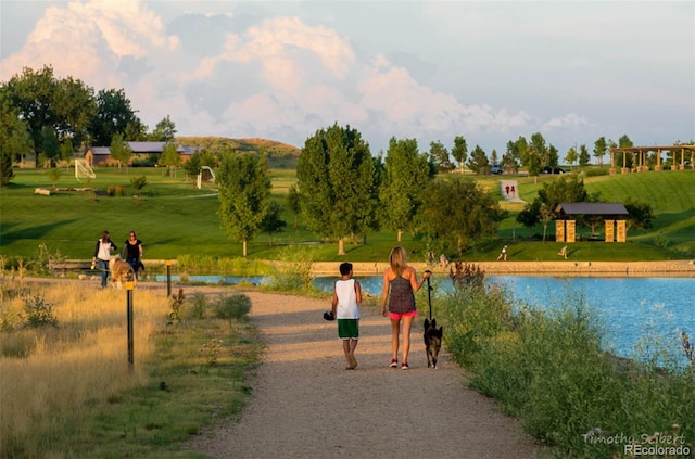 view of home's community with a gazebo, a water view, and a lawn