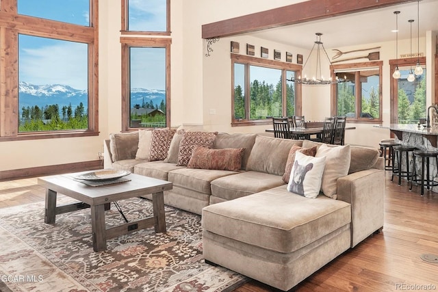 2621 Gcr 519, Tabernash, CO 80478 - living room featuring a chandelier, wood finished floors, and a mountain view