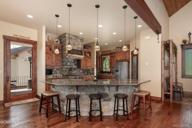 2621 Gcr 519, Tabernash, CO 80478 - kitchen with dark wood-style floors, stainless steel fridge with ice dispenser, backsplash, brown cabinets, and a large island
