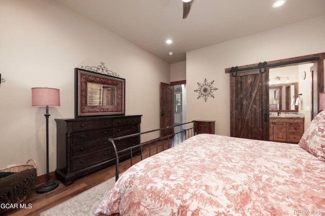 2621 Gcr 519, Tabernash, CO 80478 - bedroom featuring wood finished floors, a barn door, recessed lighting, connected bathroom, and baseboard heating