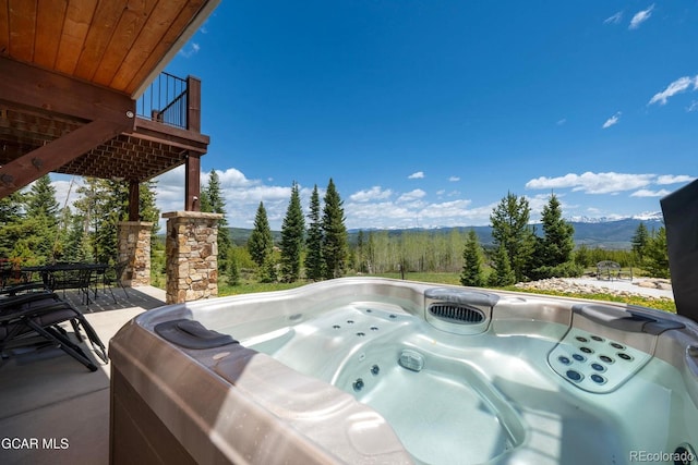 2621 Gcr 519, Tabernash, CO 80478 - view of patio with a hot tub, outdoor dining area, and a deck with mountain view