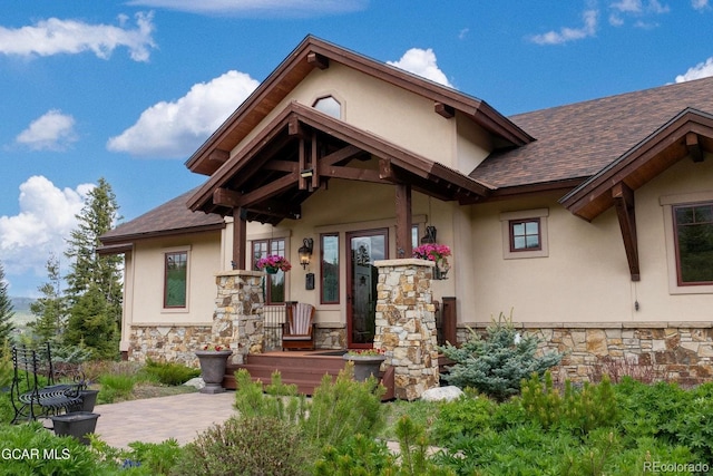 2621 Gcr 519, Tabernash, CO 80478 - view of exterior entry featuring stone siding, a shingled roof, and stucco siding
