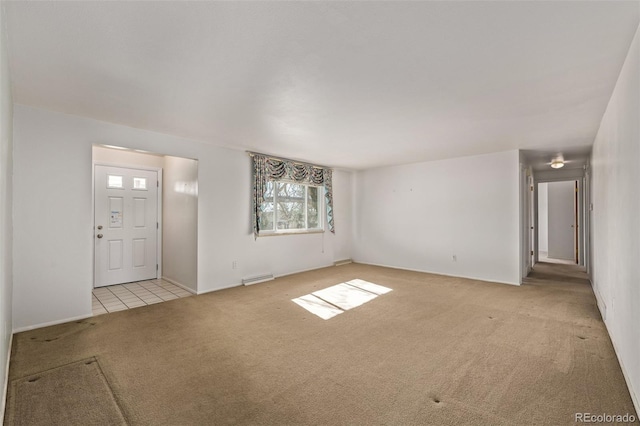 foyer entrance with visible vents and light colored carpet