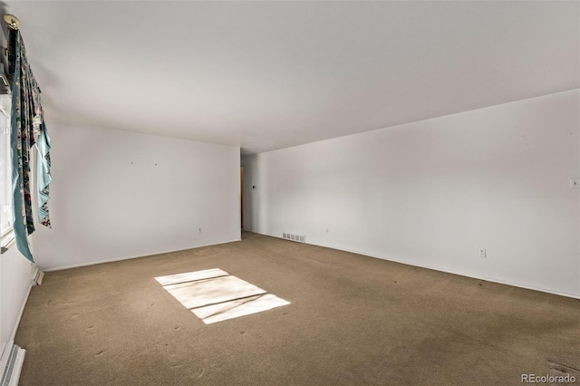 unfurnished room with visible vents and carpet flooring