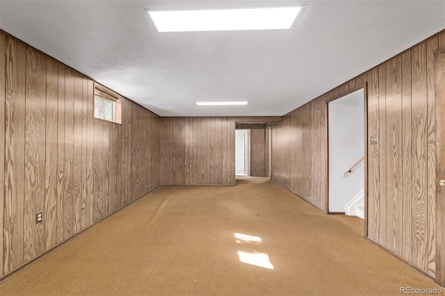 finished below grade area with light colored carpet and wood walls