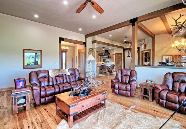 living room featuring recessed lighting, a textured ceiling, beamed ceiling, wood-type flooring, and ceiling fan with notable chandelier