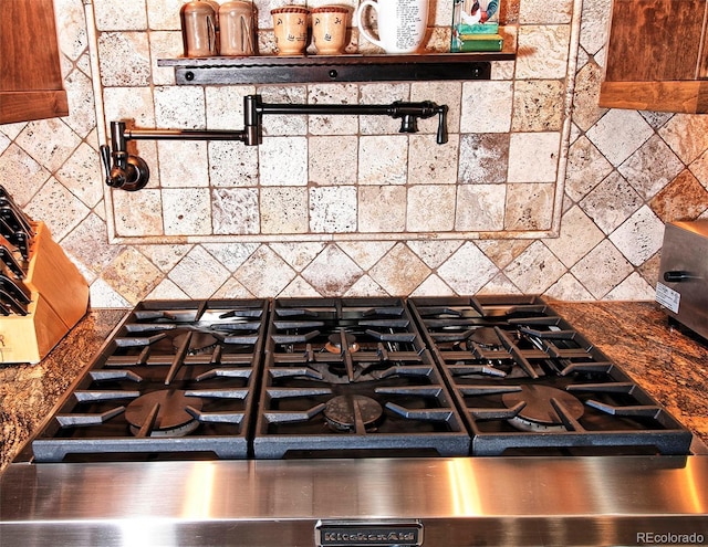 details featuring stove and decorative backsplash