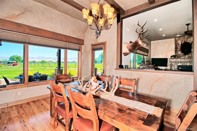 dining area with plenty of natural light, beamed ceiling, hardwood / wood-style flooring, and baseboards