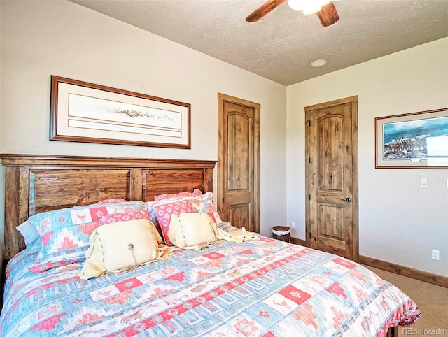bedroom featuring a textured ceiling, ceiling fan, baseboards, and carpet