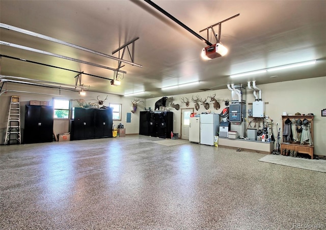 garage featuring a garage door opener, freestanding refrigerator, and water heater