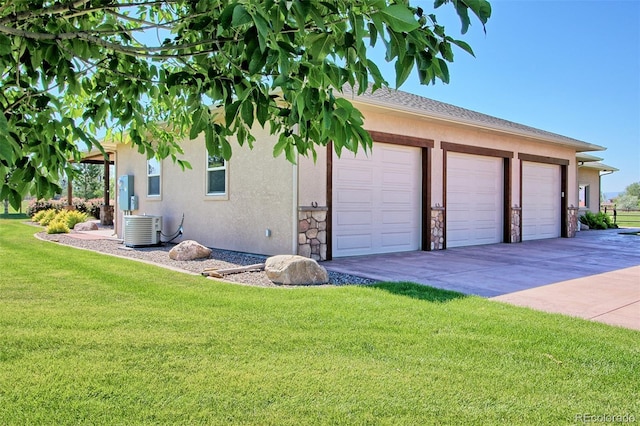 garage with concrete driveway and cooling unit