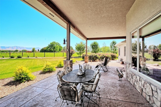 view of patio / terrace featuring outdoor dining space and a mountain view