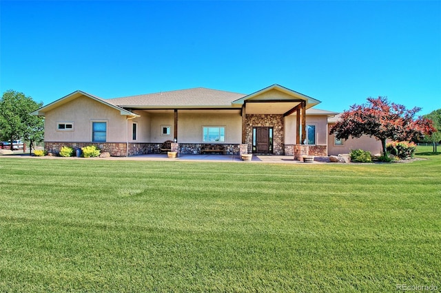 view of front of house featuring a front lawn, stone siding, and stucco siding