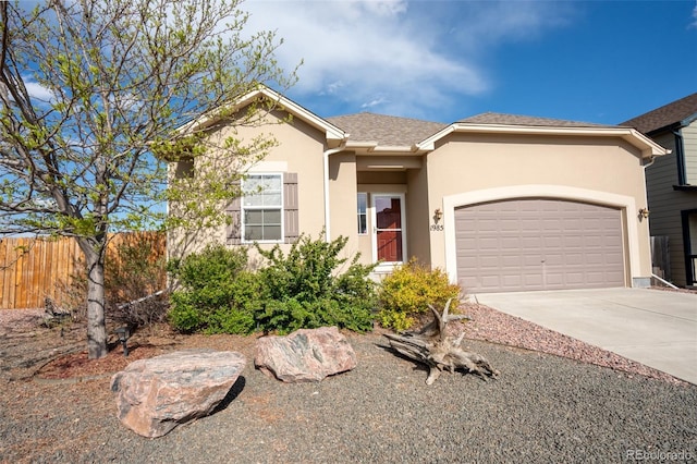 1985 Reed Grass Way, Colorado Springs, CO 80915 - single story home with stucco siding, driveway, and a garage