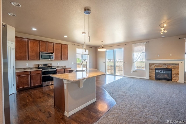 1985 Reed Grass Way, Colorado Springs, CO 80915 - kitchen featuring stainless steel appliances, dark wood-style floors, healthy amount of natural light, open floor plan, and recessed lighting