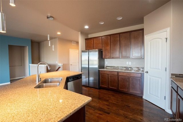 1985 Reed Grass Way, Colorado Springs, CO 80915 - kitchen featuring appliances with stainless steel finishes, light stone counters, dark wood-type flooring, recessed lighting, and pendant lighting