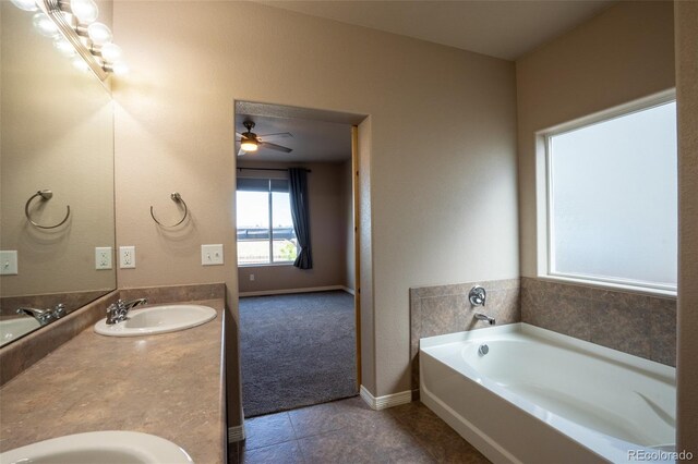 1985 Reed Grass Way, Colorado Springs, CO 80915 - full bath with double vanity, a bath, tile patterned floors, and ceiling fan