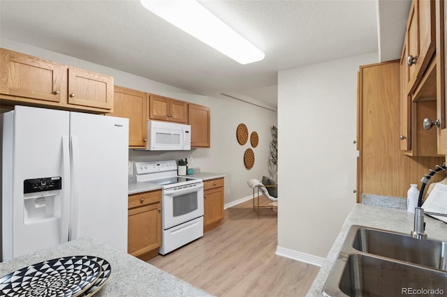 4109 Sunny Vista Hts, Colorado Springs, CO 80918 - kitchen featuring white appliances, light countertops, light wood finished floors, and a textured ceiling