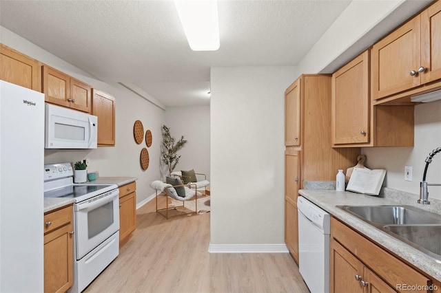 4109 Sunny Vista Hts, Colorado Springs, CO 80918 - kitchen with white appliances, light wood-style floors, light countertops, and a textured ceiling