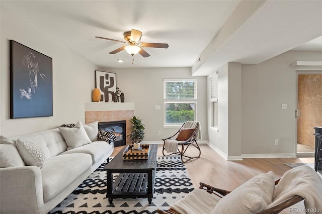 4109 Sunny Vista Hts, Colorado Springs, CO 80918 - living area with light wood-style floors, a ceiling fan, and a tile fireplace