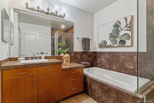 bathroom with vanity, tile patterned flooring, and plus walk in shower