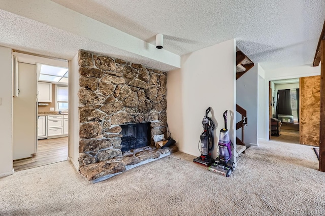 4484 Juniper Ct, Larkspur, CO 80118 - living room with light carpet, a fireplace, and a textured ceiling