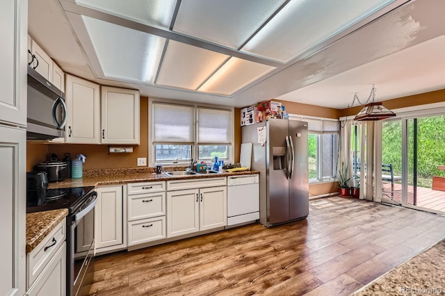 4484 Juniper Ct, Larkspur, CO 80118 - kitchen featuring stainless steel appliances, light wood-type flooring, and plenty of natural light