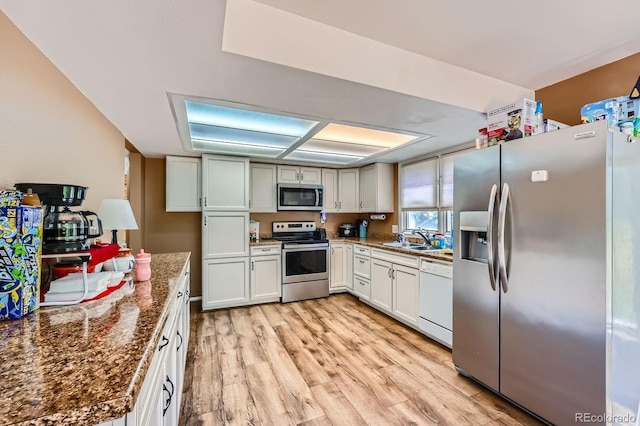 4484 Juniper Ct, Larkspur, CO 80118 - kitchen with stainless steel appliances, light wood-style floors, and dark stone counters