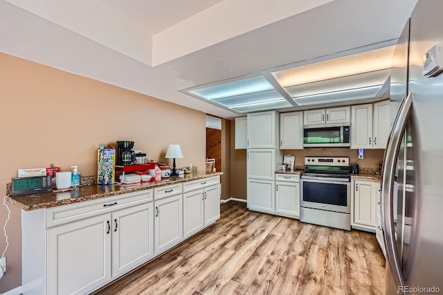 4484 Juniper Ct, Larkspur, CO 80118 - kitchen with appliances with stainless steel finishes, light wood-style flooring, white cabinets, and dark stone counters