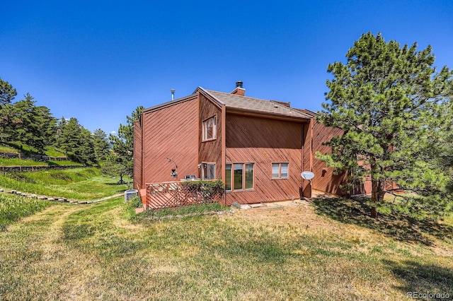 4484 Juniper Ct, Larkspur, CO 80118 - back of house with a chimney and a yard
