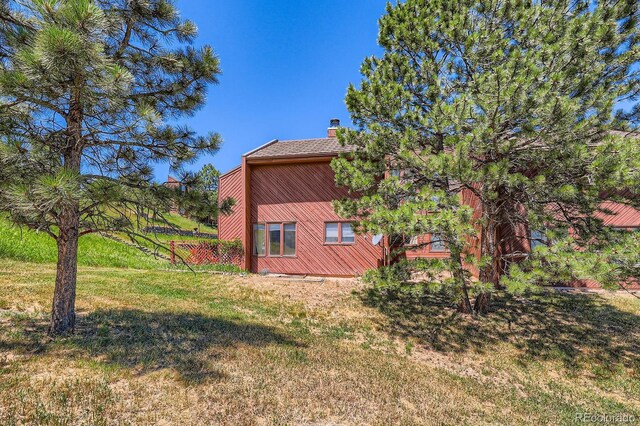 4484 Juniper Ct, Larkspur, CO 80118 - view of side of home with a chimney and a yard