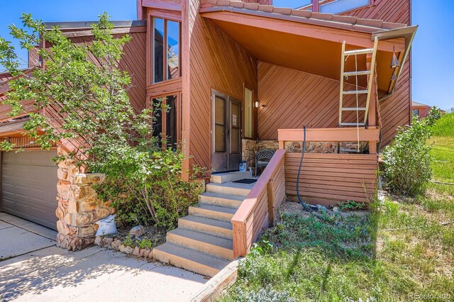 4484 Juniper Ct, Larkspur, CO 80118 - doorway to property featuring driveway and stone siding