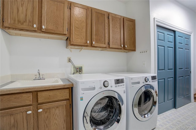 washroom featuring cabinets, separate washer and dryer, and sink