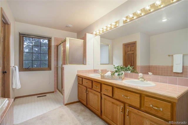 bathroom with vanity and a shower with door