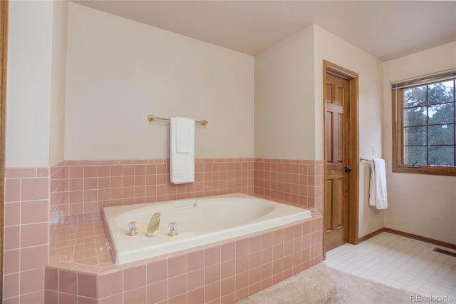 bathroom with tiled bath